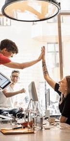 People raising hands at the bar